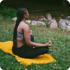 woman meditating on a yellow mat
